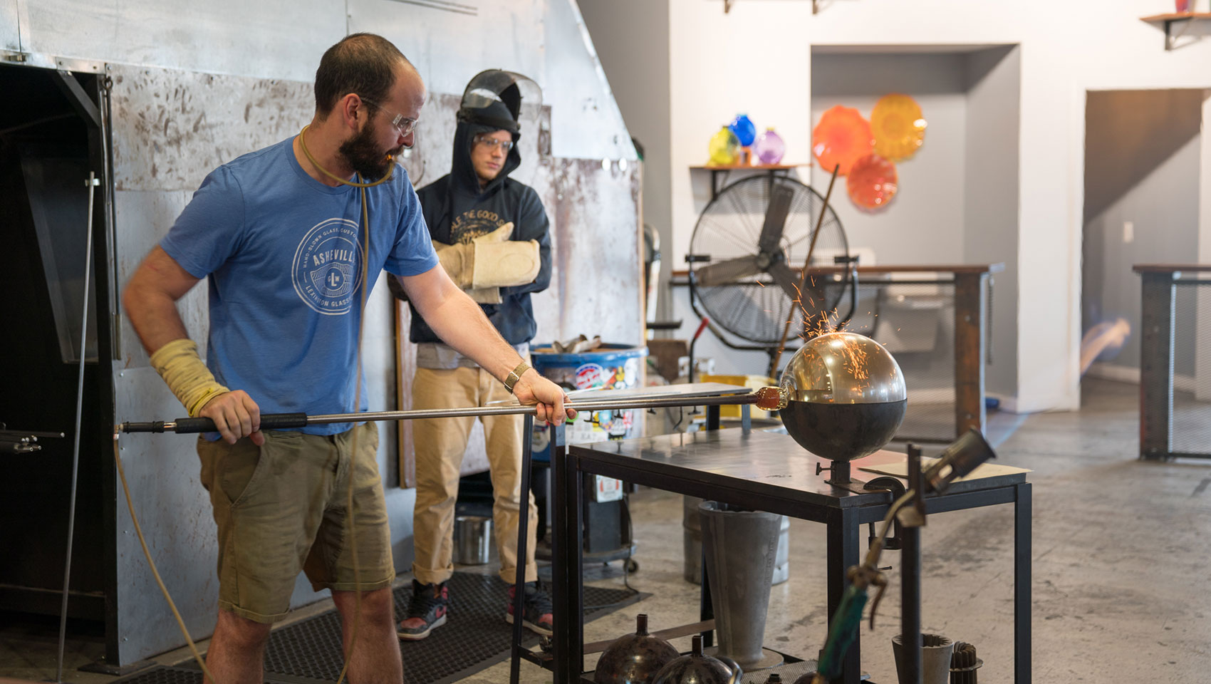 artist blowing glass