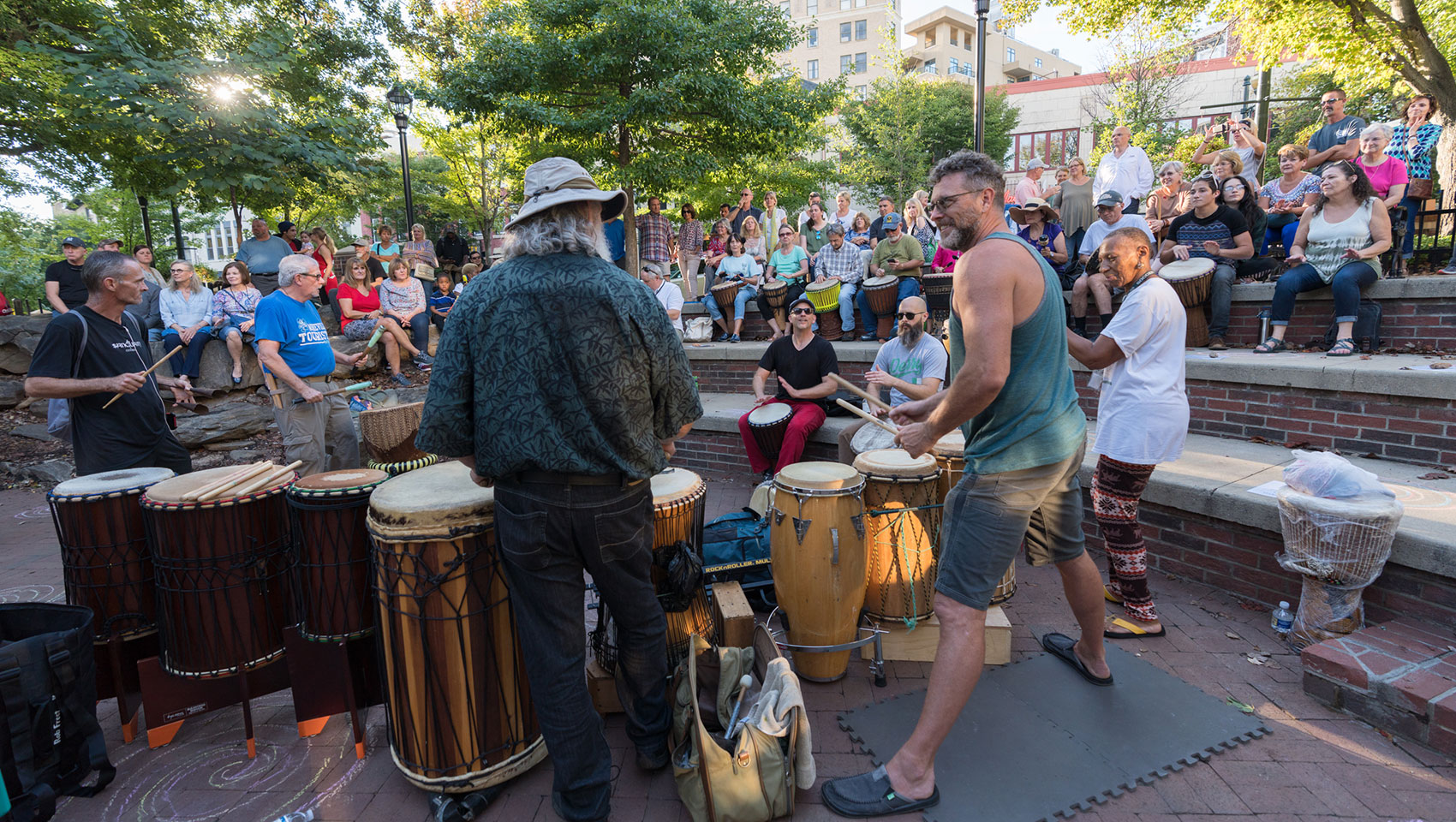 people playing music and using drums