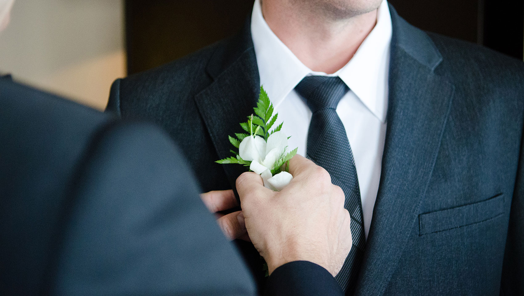 man in a suit with a flower