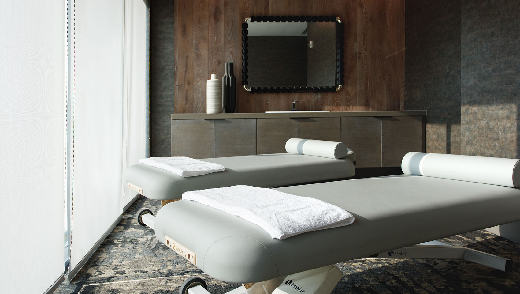 Urban Exhale Massage tables with mounted tv in the background