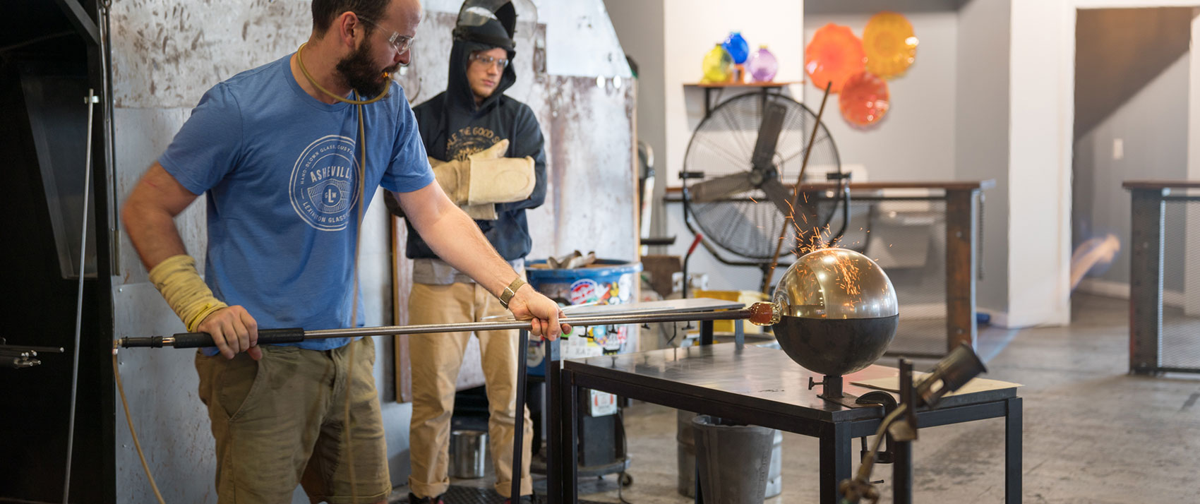 artist blowing glass